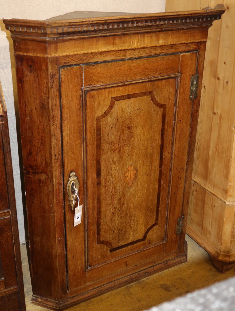 A George III inlaid oak hanging corner cupboard, W.73cm, D.45cm, H.100cm